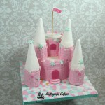 Bespoke Designer Celebration Cakes Two tiers Pink sponge Princess Castle with towers with snowflakes frozen