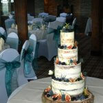 Semi naked wedding cake with blackberries, blueberries, figs and thistle Milton Keynes, Northampton, Bedfordshire
