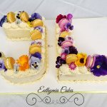 Celebration cakes Joint birthday butter cream cake with fresh edible flowers and French Macarons