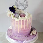 Purple and silver marble butter cream cake with white chocolate drip and fresh flowers