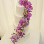 Luxury Wedding Cakes Eva Cockrell Cake Design White wedding cake with purple flower cascade