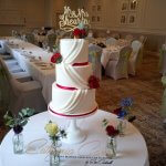Luxury Wedding Cakes Eva Cockrell Cake Design White and red draped wedding cake with fresh flowers