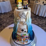 Luxury Wedding Cakes Eva Cockrell Cake Design Star Wars Lego reveal wedding cake with navy blue ombre and bride and groom lego figures in Hanbury Manor by Marriott