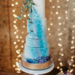 Luxury Wedding Cakes Eva Cockrell Cake Design Featured in Whimsical Wonderland Weddings this beautiful blue and purple wedding cake with edible sugar flowers