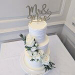 Luxury Wedding Cakes Eva Cockrell Cake Design Textured white cream cake with fresh roses in Chicheley Hall by Eva Cockrell Cake Design