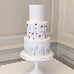 Luxury Wedding Cakes Eva Cockrell Cake Design Lilac Edible petals and painted bottom tier in Chicheley Hall by Eva Cockrell Cake Design