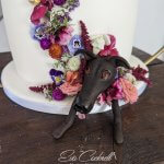 Edible flowers from Nurtured in Norfolk on wedding cake with greyhound edible figure