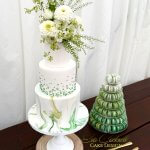 3 tier white and green marble wedding cake with green ombre pearls and macaron tower