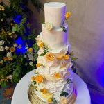 5 tier white and yellowe wedding cake with sugar ruffles and fresh flowers by Eva Cockrell Cake Design