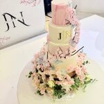 Asian Indian Wedding Cake with pink marble, edible flowers and butterflies at Whittlebury hall
