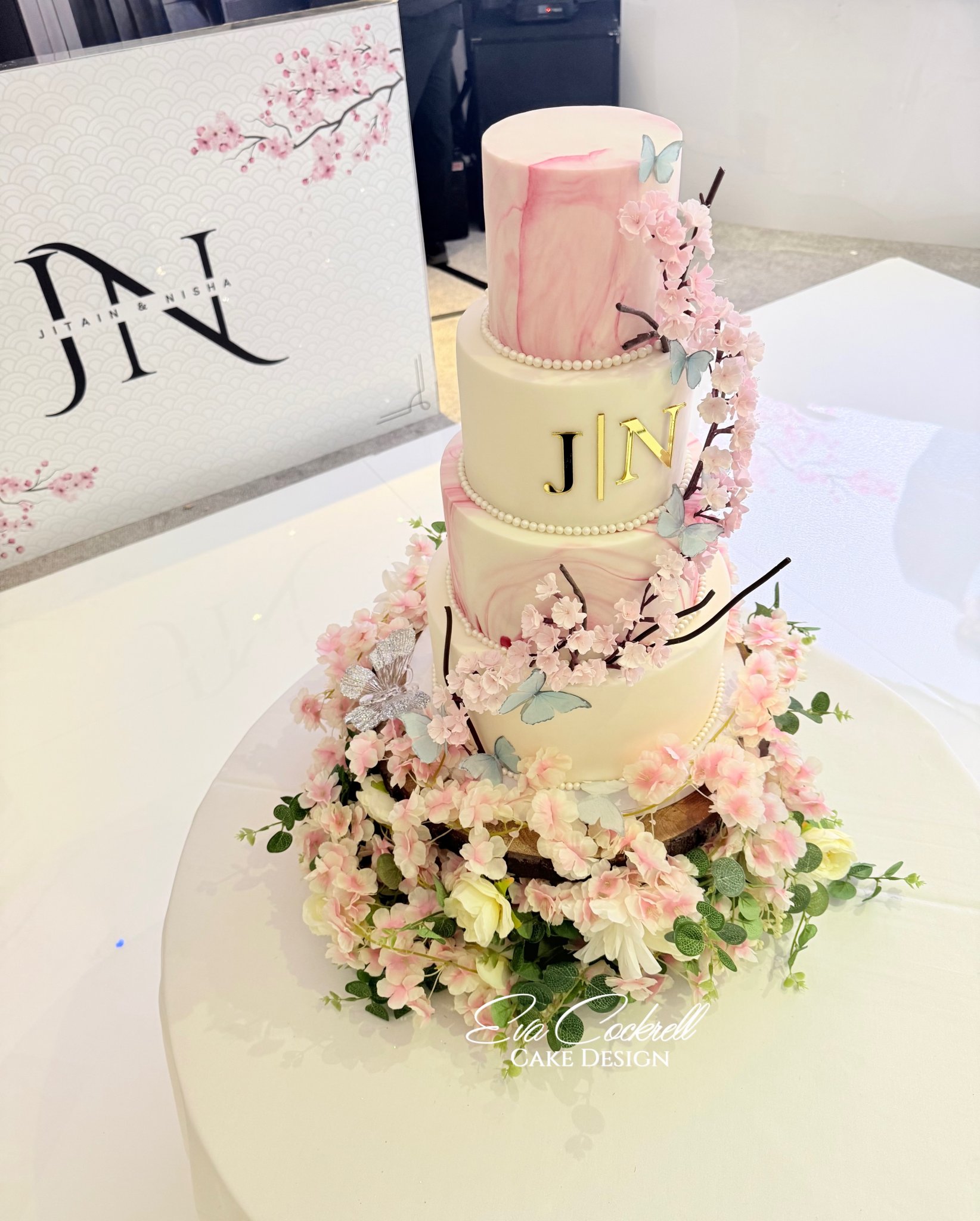 Best Asian Indian Wedding Cake with pink marble, edible flowers and butterflies at Whittlebury hall Northamptonshire
