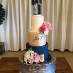 3 tier champagne gold and navy blue wedding cake with hand crafted sugar flowers and custom initials at Crockwell Farm